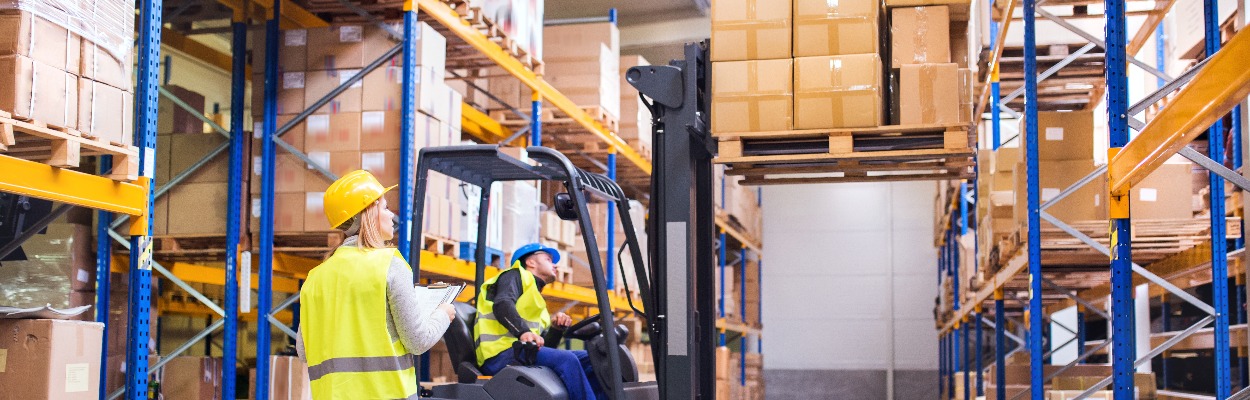 Young warehouse workers working together.