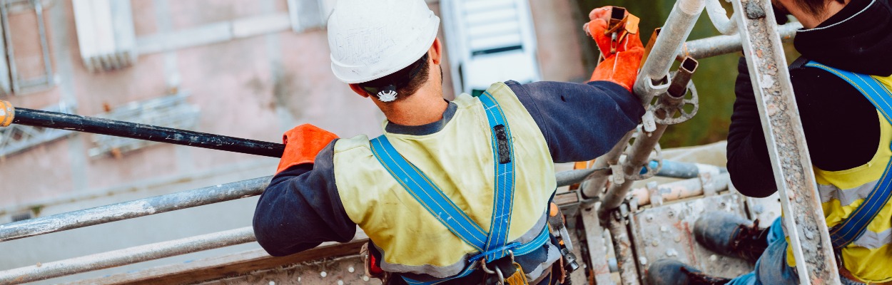 workers work removing a scaffolding at high altitude in Oviedo, Asturias, Spain.